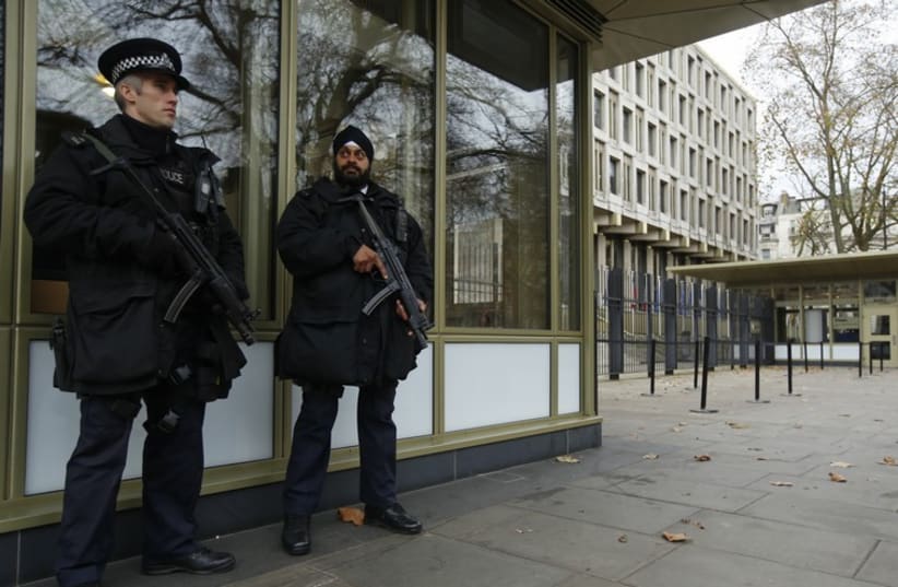 Police officers patrol outside the US embassy in London December 9, 2014.  (photo credit: REUTERS)