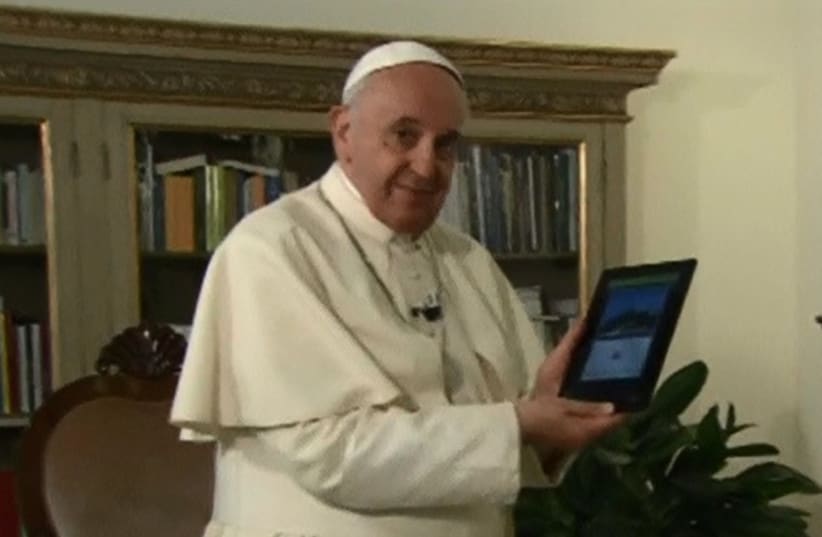 Pope uses tablet to illuminate world's biggest christmas tree in Italy (photo credit: screenshot)