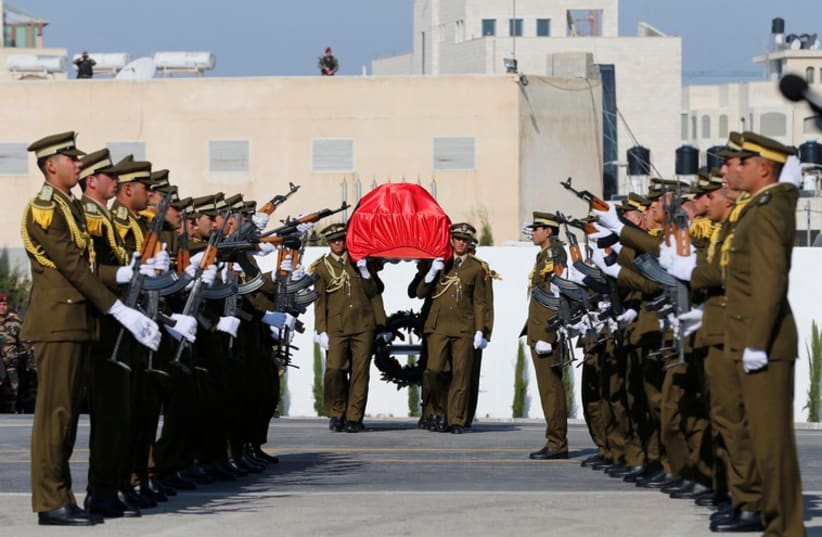 Palestinian honor guards carry the coffin of Palestinian minister Ziad Abu Ein during his funeral in the West Bank city of Ramallah December 11 (photo credit: REUTERS)