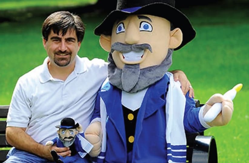 AMERICAN TOYMAKER Neal Hoffman poses with a prototype of his Mensch on a Bench. (photo credit: PR)