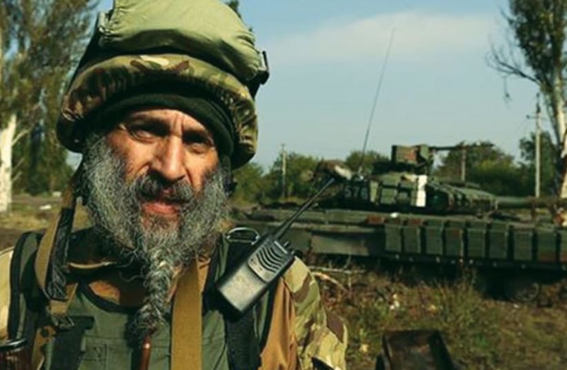 HASSIDIC SOLDIER Asher Joseph Cherkassky stands near a tank in eastern Ukraine. (photo credit: FACEBOOK)