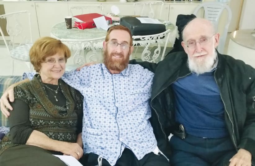 Yehudah Glick with his parents, recovering in Jerusalem. (photo credit: ORIT ARFA)