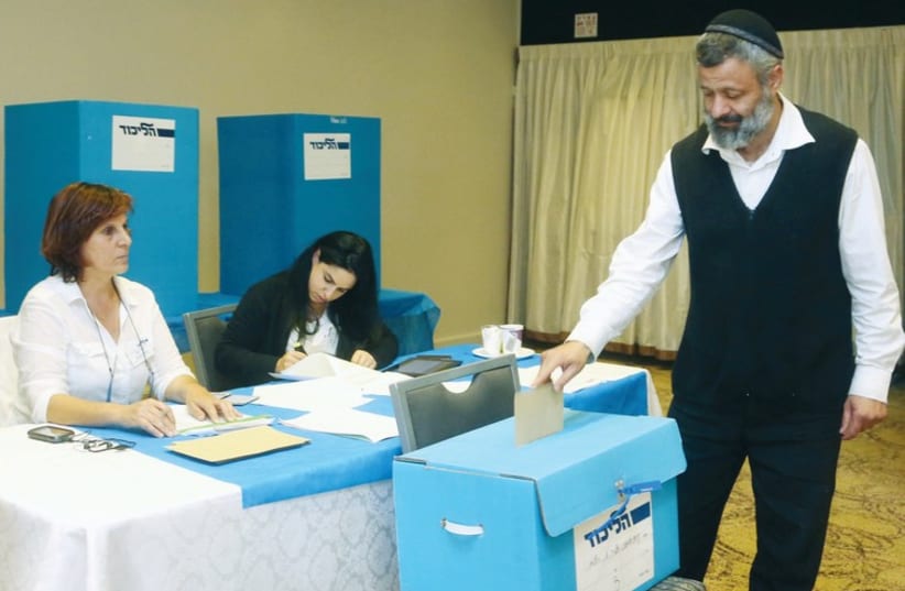 A man votes in the Likud’s internal elections. (photo credit: MARC ISRAEL SELLEM/THE JERUSALEM POST)
