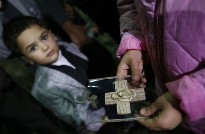 An Iraqi boy looks on in a church in Iraq (photo credit: REUTERS)
