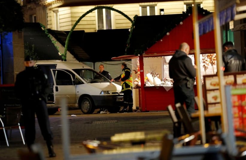 French police investigators work near a van which was driven into a crowd in Nantes December 22 (photo credit: REUTERS)