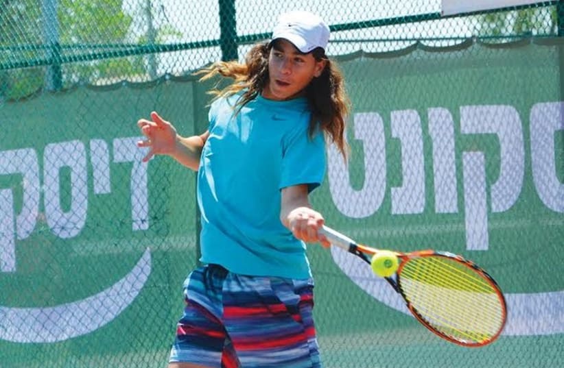 Israeli tennis star Yshai Oliel became the ninth male to capture both the 12s and 14s titles yesterday at the Junior Orange Bowl International in Florida. (photo credit: ITA/COURTESY)