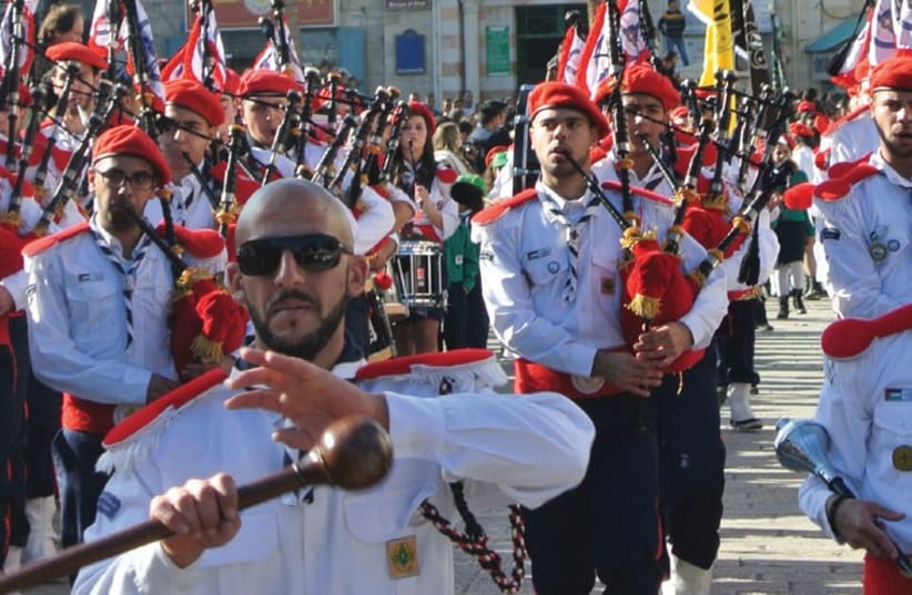 PALESTINIAN CHRISTIAN scouts march in a procession as thousands await the arrival of the Latin patriarch at Manger Square in Bethlehem. (photo credit: SETH J. FRANTZMAN)