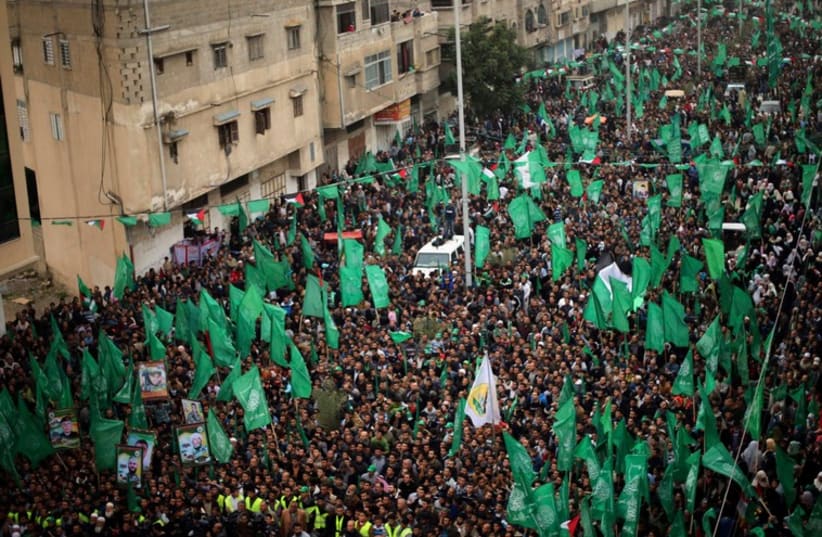 Palestinians Hamas supporters take part in a rally ahead of the 27th anniversary of the movement founding, in Jabaliya in the northern Gaza Strip (photo credit: REUTERS)