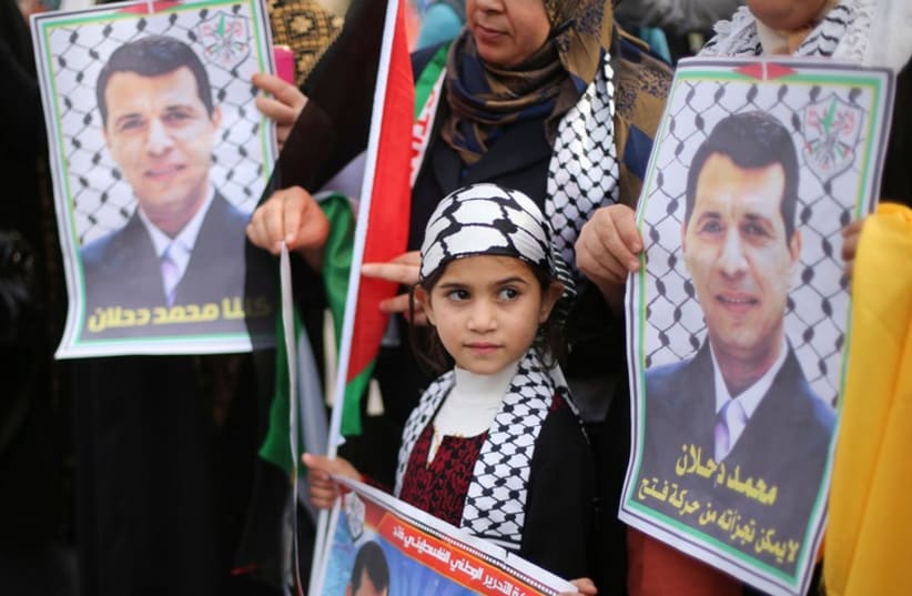 Palestinians hold posters of Mohammed Dahlan during a Gaza rally, December 18, 2014 (photo credit: REUTERS)