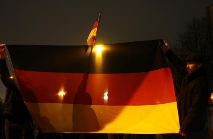 Participants of a grass-roots anti-Muslim movement hold German flags during a demonstration in Berlin (photo credit: REUTERS)