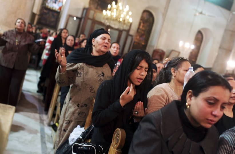 Coptic Orthodox Christian pray during a religious session by father Makary at St Mark Cathedral in Cairo (photo credit: REUTERS)