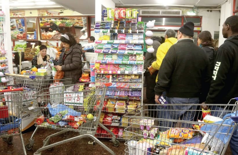 JERUSALEMITES STOCK UP on essentials yesterday, in anticipation of a tempest. (photo credit: MARC ISRAEL SELLEM/THE JERUSALEM POST)