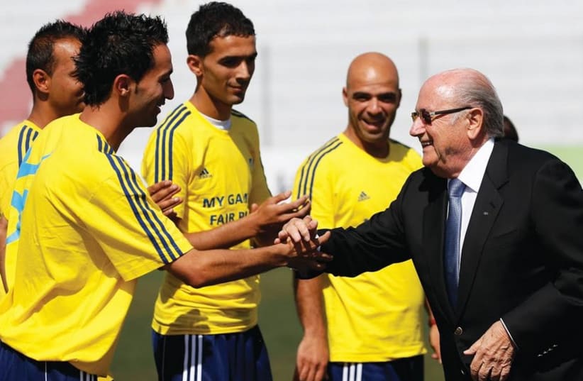 FIFA President Sepp Blatter with Palestinian soccer coaches (photo credit: REUTERS)