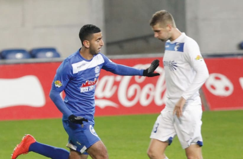 Maccabi Petah Tikva’s Marwan Kabha (left) celebrates after scoring his team’s third goal in last night’s 3-0 victory over Ironi Kiryat Shmona. (photo credit: ADI AVISHAI)