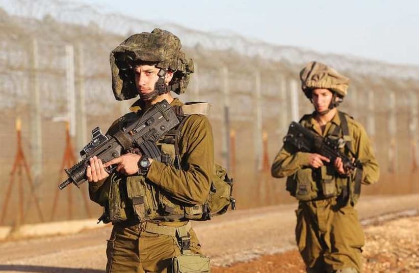 FOR SOLDIERS, long periods of waiting are accompanied by the awareness of the possibility of sudden, extreme danger. (photo credit: MARC ISRAEL SELLEM/THE JERUSALEM POST)