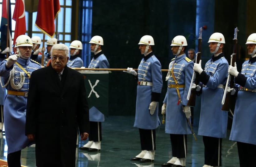 Palestinian Authority President Mahmoud Abbas reviews the guards of honour during a welcoming ceremony at the Presidential Palace in Ankara January 12 (photo credit: REUTERS)