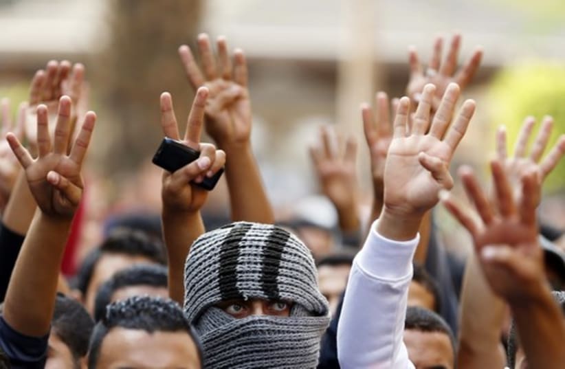 The Rabaa sign is flashed, symbolizing support for the Muslim Brotherhood (photo credit: REUTERS)