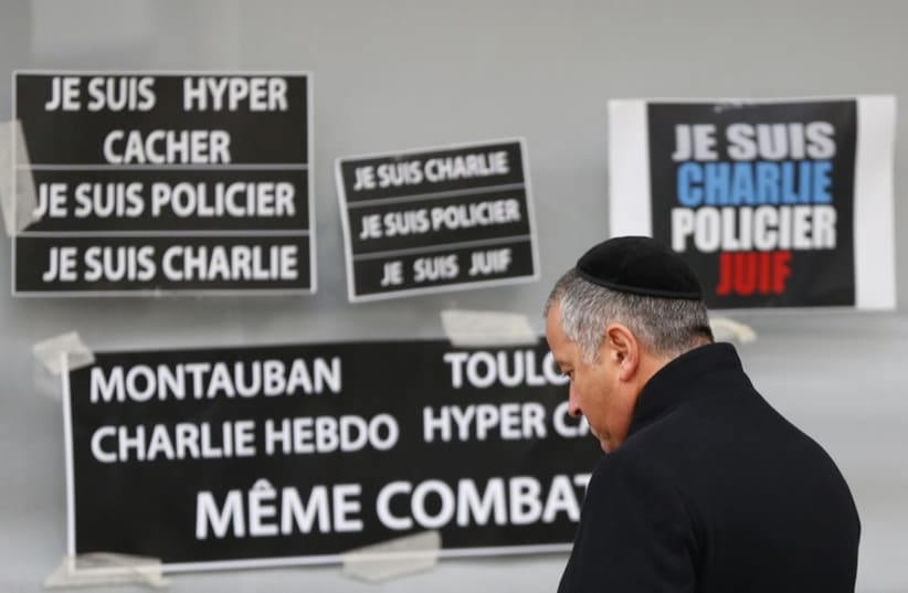 French Jewish man pays repsects to victims of terror attack (photo credit: REUTERS)