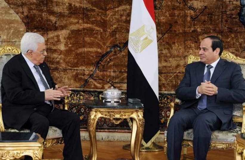 Egyptian President Abdel Fattah al-Sisi (R) meets with Palestinian President Mahmoud Abbas in Cairo, January 14, 2015 (photo credit: REUTERS)