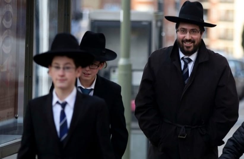 A Jewish man and boys in London (photo credit: REUTERS)