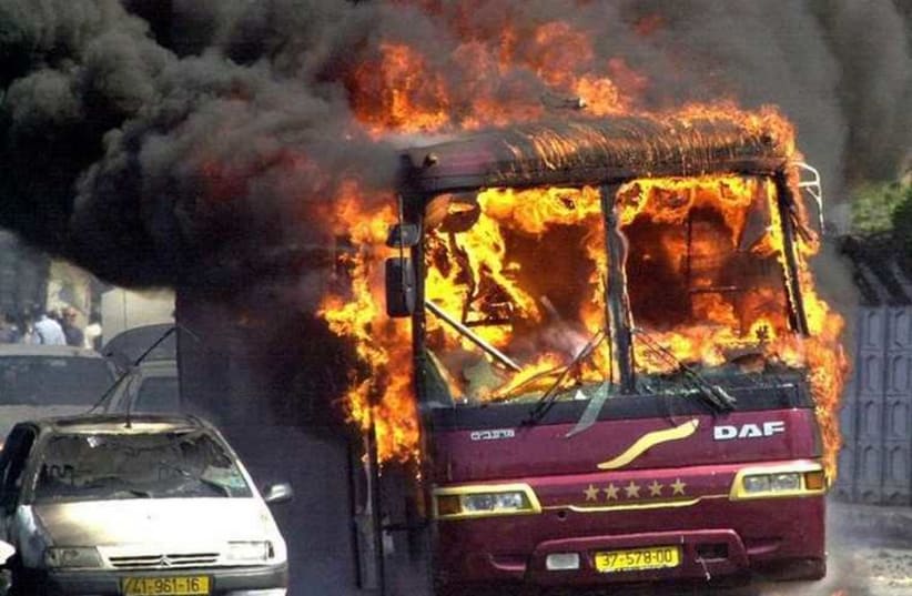 A bus burns where a car bomb exploded at Beit Lid junction near Netanya, September 9, 2001 (photo credit: REUTERS)