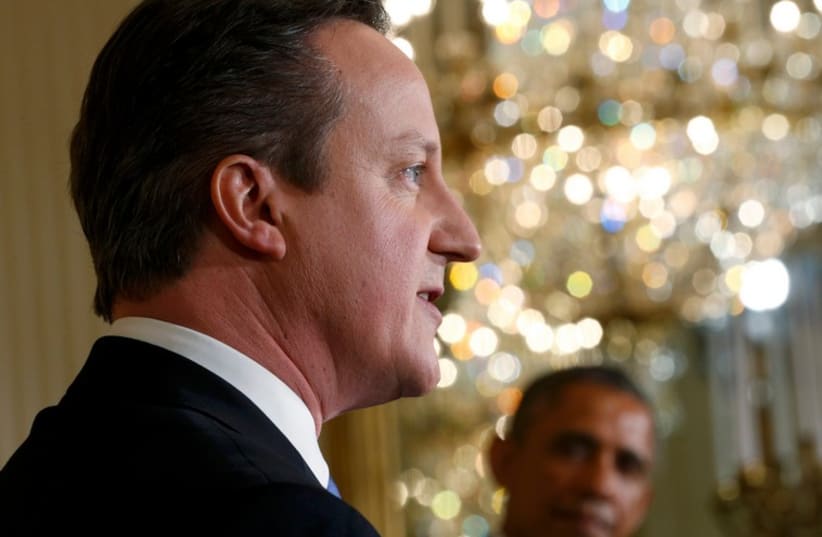 British Prime Minister David Cameron speaks as US President Barack Obama looks on at the White House (photo credit: REUTERS)