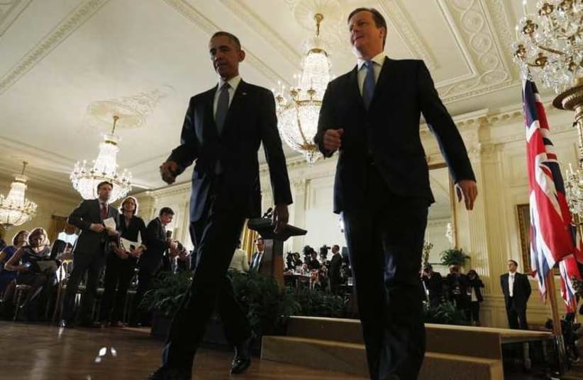 British Prime Minister David Cameron (R) and US President Barack Obama leave a news conference at the White House (photo credit: REUTERS)