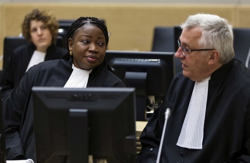 International Criminal Court prosecutor Fatou Bensouda speaks with her deputy, James Stewart, at an ICC hearing in March 2014 (photo credit: REUTERS)