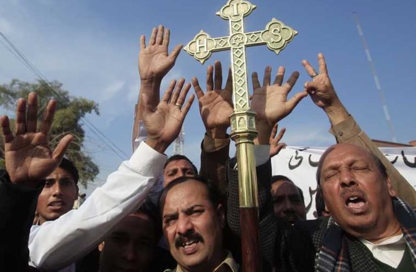 Pakistan's Christian community protest against satirical French weekly Charlie Hebdo, which featured a cartoon of the Prophet Mohammad as the cover of its first edition since an attack by Islamist gunmen, in Peshawar. (photo credit: REUTERS)