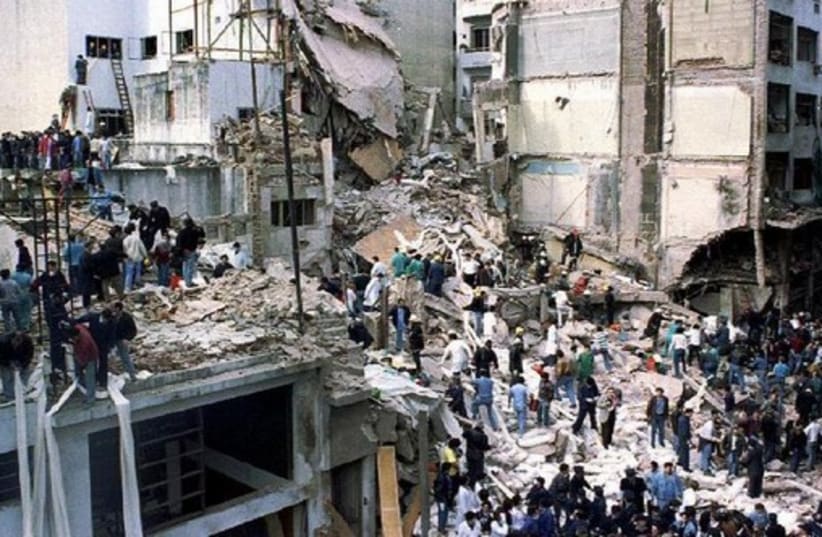 Rescue workers search for survivors and victims in the rubble left after a powerful car bomb destroyed the Buenos Aires headquarters of the Argentine Israeli Mutual Association (AMIA), in this July 18, 1994 file photo (photo credit: REUTERS)