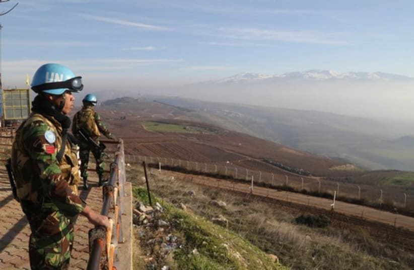 UNIFIL troops stand on a lookout point in Kfar Kila village near the Lebanese-Israeli border, in south Lebanon (photo credit: REUTERS)