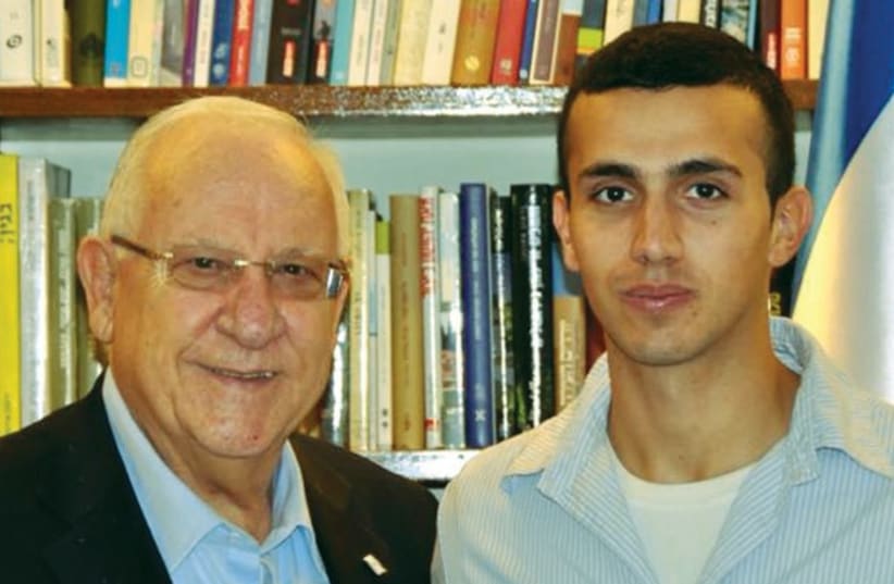 PRESIDENT REUVEN RIVLIN and Tommy Hasson appear in an undated picture on the head of state’s Facebook page. (photo credit: FACEBOOK)
