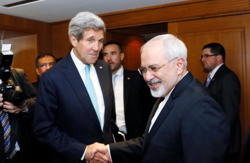 U.S. Secretary of State John Kerry shakes hands with Iranian Foreign Minister Mohammad Javad Zarif. (photo credit: REUTERS)