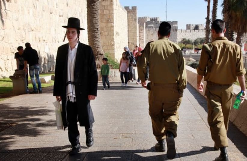Haredi man and IDF soldiers in Jerusalem. (photo credit: MARC ISRAEL SELLEM)