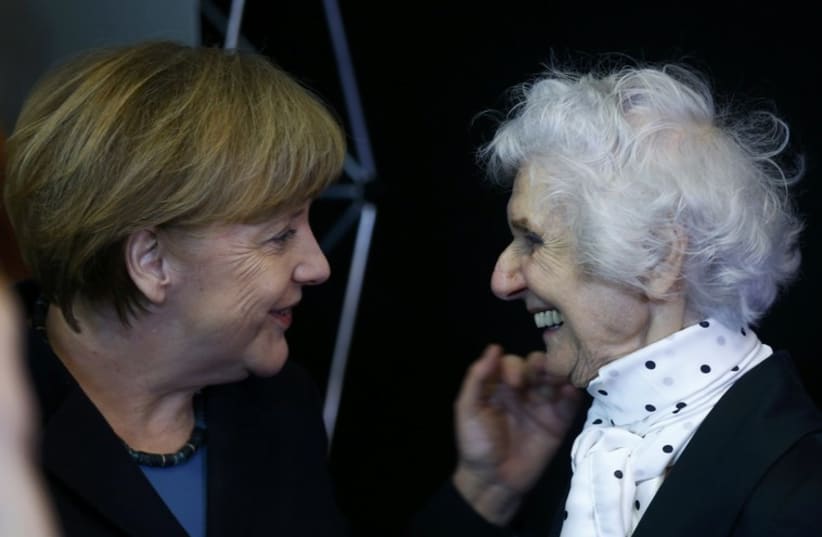 German Chancellor Merkel and Auschwitz survivor Fahidi attend the opening event for the international remembrance of the 70th anniversary of the Liberation of Auschwitz in Berlin. (photo credit: REUTERS)