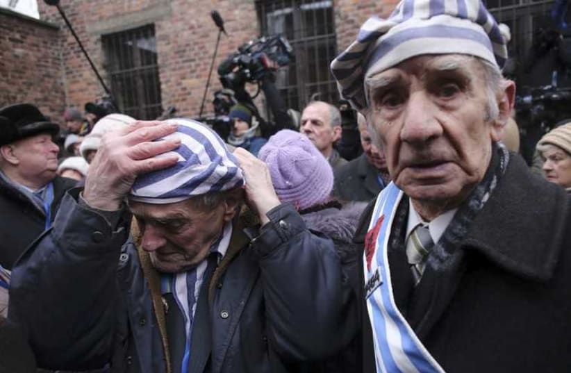 Survivors of the former Nazi German concentration and extermination camp Auschwitz arrive to the former camp in Oswiecim. (photo credit: REUTERS)
