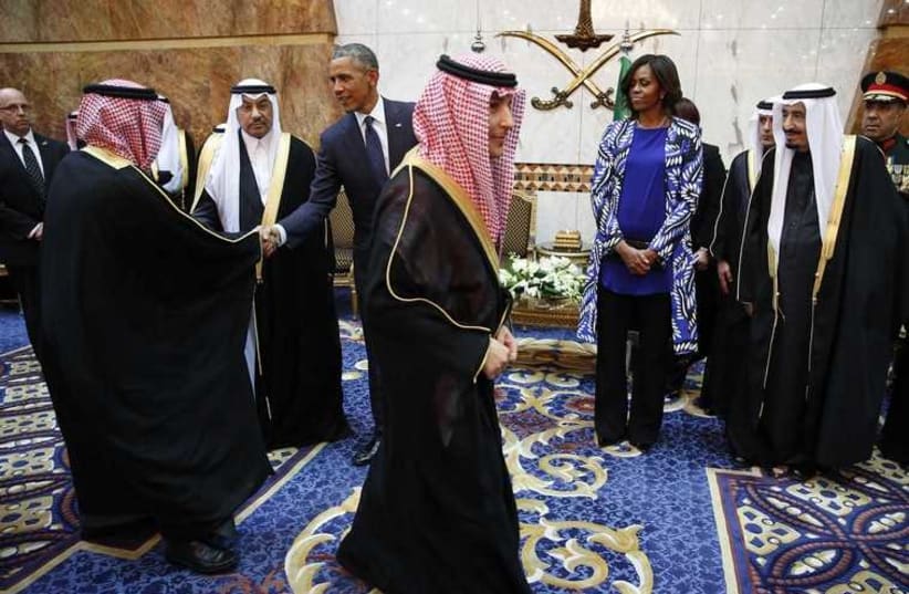 US President Barack Obama  and First Lady Michelle Obama meet members of the Saudi royal family, government officials and guests (photo credit: REUTERS)