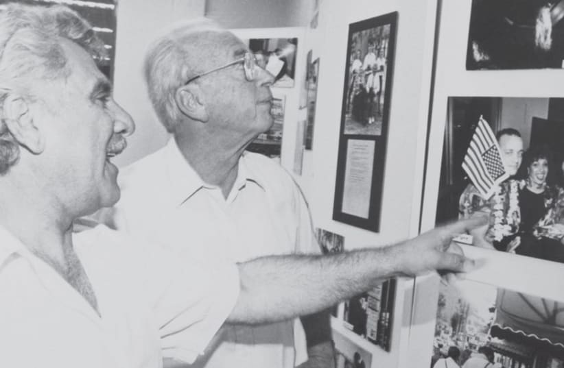 Sami Farag shows prime minister Yitzhak Rabin a portrait of Israeli and American soldiers. (photo credit: Courtesy)