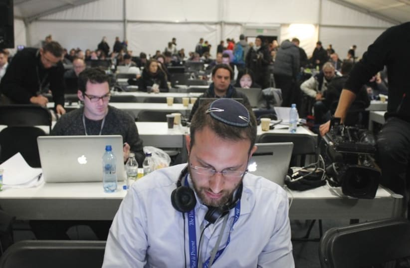 Sam Sokol works on Tuesday in the press tent set up just outside Auschwitz (photo credit: SAM SOKOL)