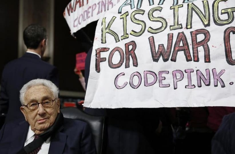 Former United States Secretary of State Henry Kissinger sits calmly as Code Pink demonstrators demand his arrest (photo credit: REUTERS)