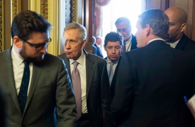 Senate Minority Leader Harry Reid (D-NV) walks from the Democratic caucus luncheon on Capitol Hill in Washington (photo credit: REUTERS)
