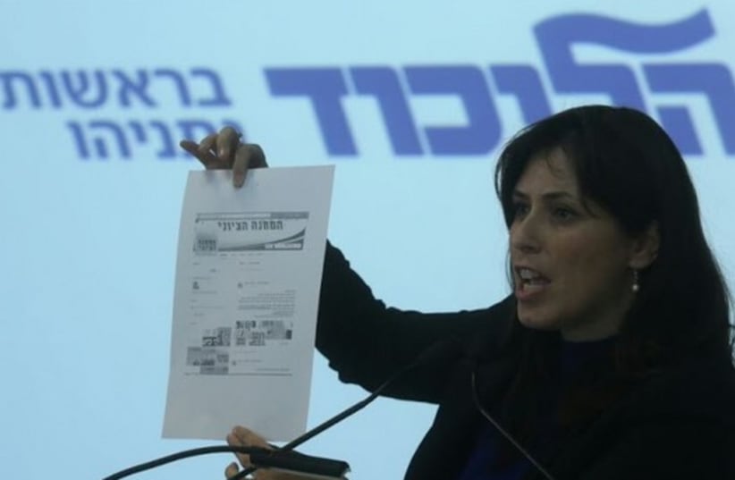 Hotovely holds up screenshot of Labor website with V15 link. (photo credit: MARC ISRAEL SELLEM/THE JERUSALEM POST)