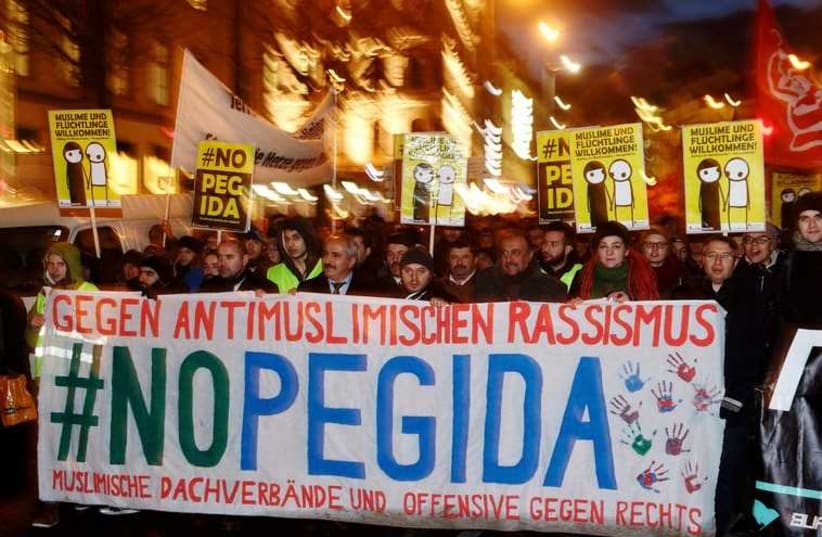 Supporters of the movement of Patriotic Europeans Against the Islamisation of the West (PEGIDA) gather during a demonstration in Vienna (photo credit: REUTERS)
