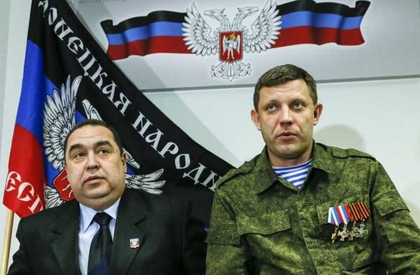 Alexander Zakharchenko (R), leader of the self-proclaimed Donetsk People's Republic (DPR), and Igor Plotnitsky, leader of the self-proclaimed Luhansk People's Republic (LPR), attend a news conference in Donetsk February 2 (photo credit: REUTERS)