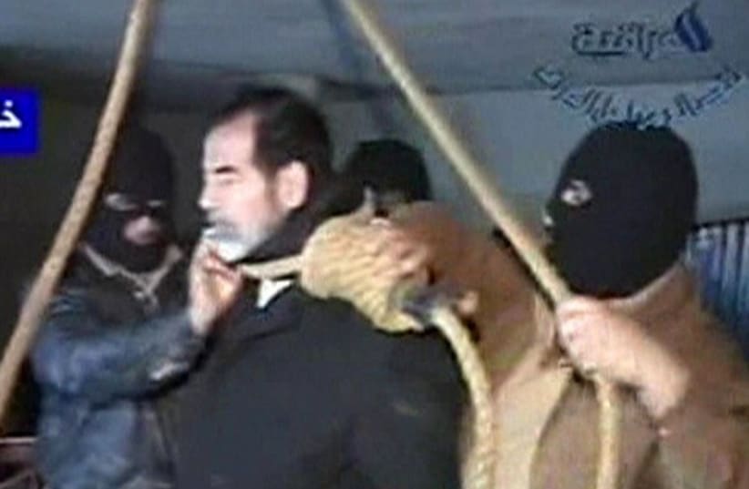 Footage from Al Iraqiya television shows masked executioners putting a noose around former Iraqi President Saddam Hussein's neck moments before his hanging in Baghdad December 30, 2006. (photo credit: REUTERS)