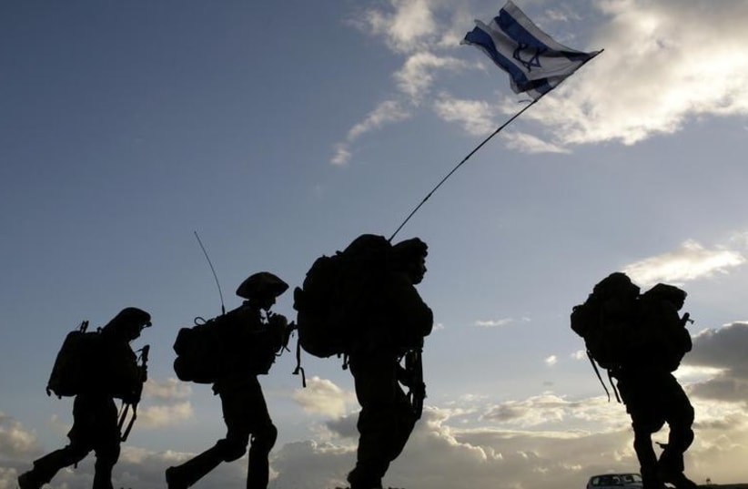 Israeli soldiers cross the Gaza border back to Israel early morning after a combat mission in Gaza (photo credit: REUTERS)