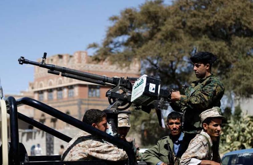 Houthi fighters ride a patrol truck in Sanaa (photo credit: REUTERS)
