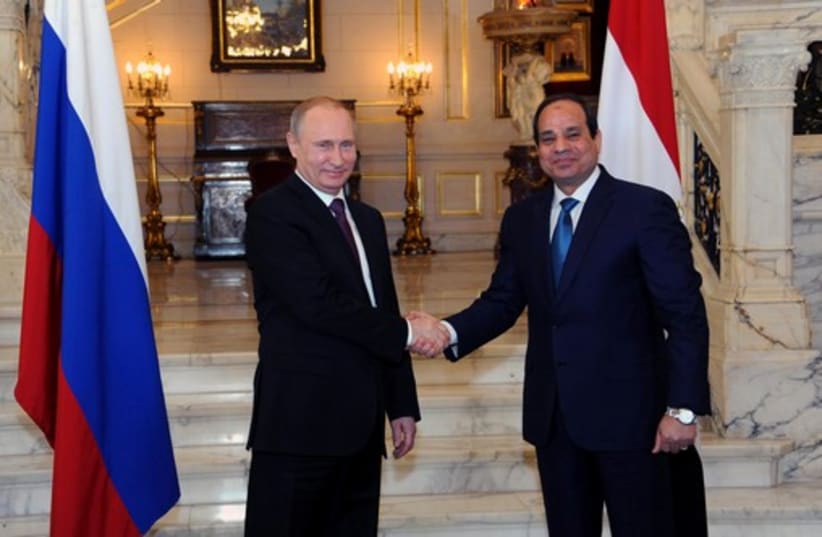 Russia's President Vladimir Putin (L) shakes hands with Egypt's President Abdel Fattah al-Sisi in Cairo (photo credit: REUTERS)