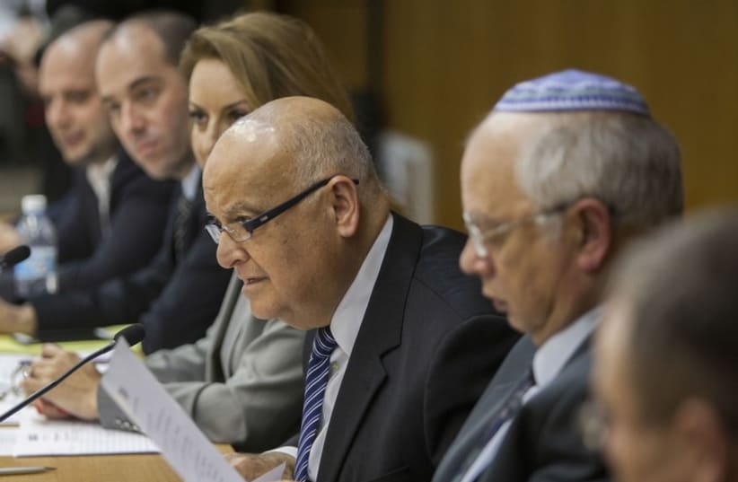 Supreme Court Judge Salim Joubran (center), head of the Central Elections Committee, accepts a party list, January 28. (photo credit: Courtesy)