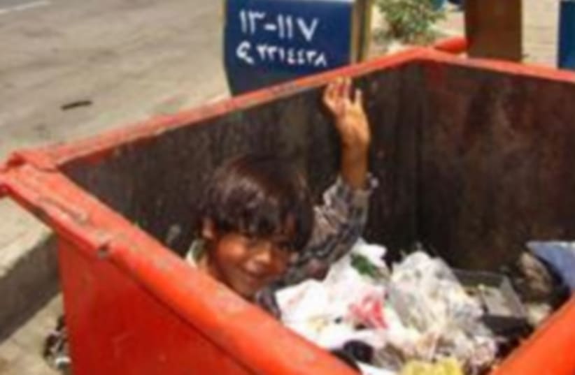 Child in trash (photo credit: IRANIAN MEDIA)